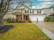 Charming two-story home with a well-manicured lawn, a covered porch, and a three car garage at 118 Glade Valley Ave, Mooresville, NC 28117