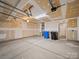 Unfinished two car garage featuring concrete flooring, overhead storage, and an entry door at 118 Glade Valley Ave, Mooresville, NC 28117