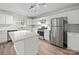Well-lit kitchen with stainless steel appliances, white cabinetry, and a center island at 118 Glade Valley Ave, Mooresville, NC 28117