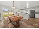 Open-concept kitchen and dining area with modern appliances, wooden table, and sliding glass doors at 118 Glade Valley Ave, Mooresville, NC 28117