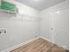 Laundry room with vinyl flooring, wire shelving, washer and dryer hookups, and a door at 118 Glade Valley Ave, Mooresville, NC 28117
