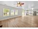 Bright living space with wood floors, ceiling fan, and an open view to the kitchen at 118 Glade Valley Ave, Mooresville, NC 28117