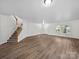 Inviting living space featuring a staircase, large window, and neutral tones creating a warm ambiance at 118 Glade Valley Ave, Mooresville, NC 28117