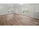 Bright room with hardwood floors and large windows, offering a versatile space with natural light at 118 Glade Valley Ave, Mooresville, NC 28117