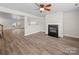 Open-concept area boasts hardwood flooring, a fireplace, and seamless access to other living spaces at 118 Glade Valley Ave, Mooresville, NC 28117