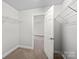 Spacious walk-in closet with shelving, door open to carpeted room at 118 Glade Valley Ave, Mooresville, NC 28117