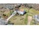 Aerial view of a traditional home with a long drive and large manicured lawn in a suburban neighborhood at 11929 Parks Farm Ln, Charlotte, NC 28277