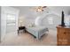 Charming bedroom with vaulted ceilings, neutral carpet, and natural light from two windows at 11929 Parks Farm Ln, Charlotte, NC 28277