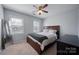 Cozy bedroom with carpet, natural light, and a modern ceiling fan fixture at 11929 Parks Farm Ln, Charlotte, NC 28277