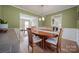 Charming dining room with hardwood floors, wainscoting, and a traditional wooden table at 11929 Parks Farm Ln, Charlotte, NC 28277