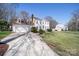 Traditional home with a two-car garage, a long driveway, and manicured landscaping at 11929 Parks Farm Ln, Charlotte, NC 28277