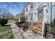 Inviting front porch featuring brick steps, white railing, and a green front door at 11929 Parks Farm Ln, Charlotte, NC 28277