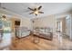 Open-concept living room with hardwood floors, neutral tones, and bright lighting at 11929 Parks Farm Ln, Charlotte, NC 28277