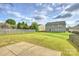 The backyard features a grassy lawn, wooden fence, and partial view of the home at 1309 Afternoon Sun Rd, Matthews, NC 28104