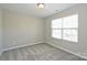 A standard bedroom with neutral paint, carpet flooring, and a window with blinds at 1309 Afternoon Sun Rd, Matthews, NC 28104