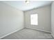 Bright bedroom featuring neutral walls, carpet, and a window providing natural light at 1309 Afternoon Sun Rd, Matthews, NC 28104