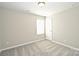 A simple bedroom with neutral carpet, and a single window at 1309 Afternoon Sun Rd, Matthews, NC 28104
