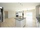 Spacious kitchen with an island and an open view into the living room with fireplace at 1309 Afternoon Sun Rd, Matthews, NC 28104