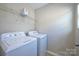Bright laundry room featuring a washer and dryer set and wire shelving at 1309 Afternoon Sun Rd, Matthews, NC 28104