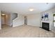 Spacious living room with fireplace, wood floors, and open layout with stairs at 1309 Afternoon Sun Rd, Matthews, NC 28104