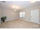 Bright living room with wood floors, chandelier, and a view to the front yard at 1309 Afternoon Sun Rd, Matthews, NC 28104