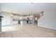 Open layout with kitchen, living room, and dining area with hardwood floors at 1309 Afternoon Sun Rd, Matthews, NC 28104