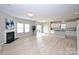Open-concept living area with a fireplace, kitchen, and access to the backyard at 1309 Afternoon Sun Rd, Matthews, NC 28104