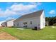 Spacious backyard featuring a well-manicured lawn, concrete patio, and a view of neighboring homes at 136 Adams Tree Way, Troutman, NC 28166