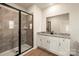 Modern bathroom with a glass-enclosed shower and granite countertop vanity is stylish at 136 Adams Tree Way, Troutman, NC 28166