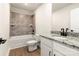 Bathroom features a tub, shower, granite counters, and neutral tiling at 136 Adams Tree Way, Troutman, NC 28166
