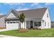 Inviting single-story home with stone veneer, a two-car garage, and a freshly landscaped yard at 136 Adams Tree Way, Troutman, NC 28166