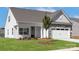 Beautiful one-story home with well-kept lawn, black front door, stone accents, and attached garage at 136 Adams Tree Way, Troutman, NC 28166