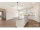 Well-appointed kitchen featuring a granite island, white cabinets, and an open view to the living area at 136 Adams Tree Way, Troutman, NC 28166