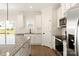Stylish kitchen with granite countertops, white cabinetry, stainless steel appliances, and an island at 136 Adams Tree Way, Troutman, NC 28166