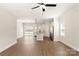 Expansive living area featuring hardwood floors, modern lighting, and an open layout to the kitchen at 136 Adams Tree Way, Troutman, NC 28166