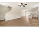Open-concept living space showcasing hardwood floors and seamless transition to the kitchen area at 136 Adams Tree Way, Troutman, NC 28166