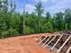 A construction site is nestled in the trees, showing a foundation being built at 14703 Keyes Meadow Way, Huntersville, NC 28078