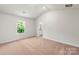 Bright bedroom featuring neutral carpet, large window, and ensuite bathroom entrance at 1588 Doran Ter, Richburg, SC 29729