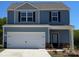 Charming two-story home featuring blue siding, black shutters, and a spacious two-car garage at 1588 Doran Ter, Richburg, SC 29729