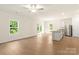 Open-concept living area featuring light wood floors, natural light, and a kitchen island with seating at 1588 Doran Ter, Richburg, SC 29729