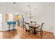 Open dining area with hardwood flooring, a chandelier, and a view into the kitchen at 16911 Commons Creek Dr, Charlotte, NC 28277