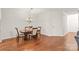 Traditional dining room features a classic chandelier, hardwood floors, and a cozy atmosphere at 16911 Commons Creek Dr, Charlotte, NC 28277