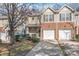 Charming townhouse exterior featuring a two-car garage and a well-maintained lawn at 16911 Commons Creek Dr, Charlotte, NC 28277