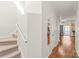 Bright hallway with hardwood floors leading to the living spaces and stairs at 16911 Commons Creek Dr, Charlotte, NC 28277