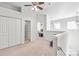 Bright, open hallway featuring neutral carpet, pendant lighting, and views into other rooms at 16911 Commons Creek Dr, Charlotte, NC 28277