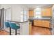 Bright kitchen with stainless steel appliances, breakfast bar, and hardwood floors at 16911 Commons Creek Dr, Charlotte, NC 28277