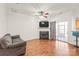 Cozy living room featuring a fireplace, hardwood flooring, and lots of natural light at 16911 Commons Creek Dr, Charlotte, NC 28277