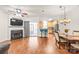 Open-concept living room featuring a fireplace, hardwood floors, and sliding door access to the outside at 16911 Commons Creek Dr, Charlotte, NC 28277