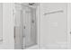 Bathroom featuring a walk-in shower with glass doors and a chrome finish at 16911 Commons Creek Dr, Charlotte, NC 28277