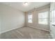 A carpeted bedroom featuring two windows and neutral paint at 1819 Lotus Ln, Denver, NC 28037